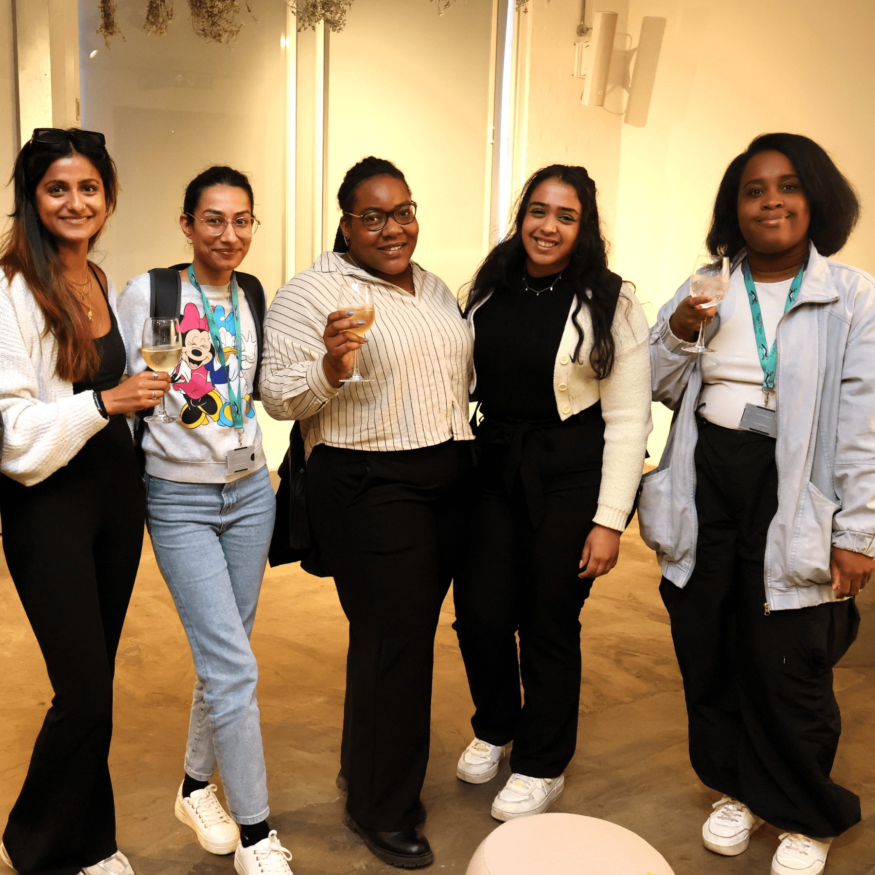 group of ladies holding glasses of wine at a networking event