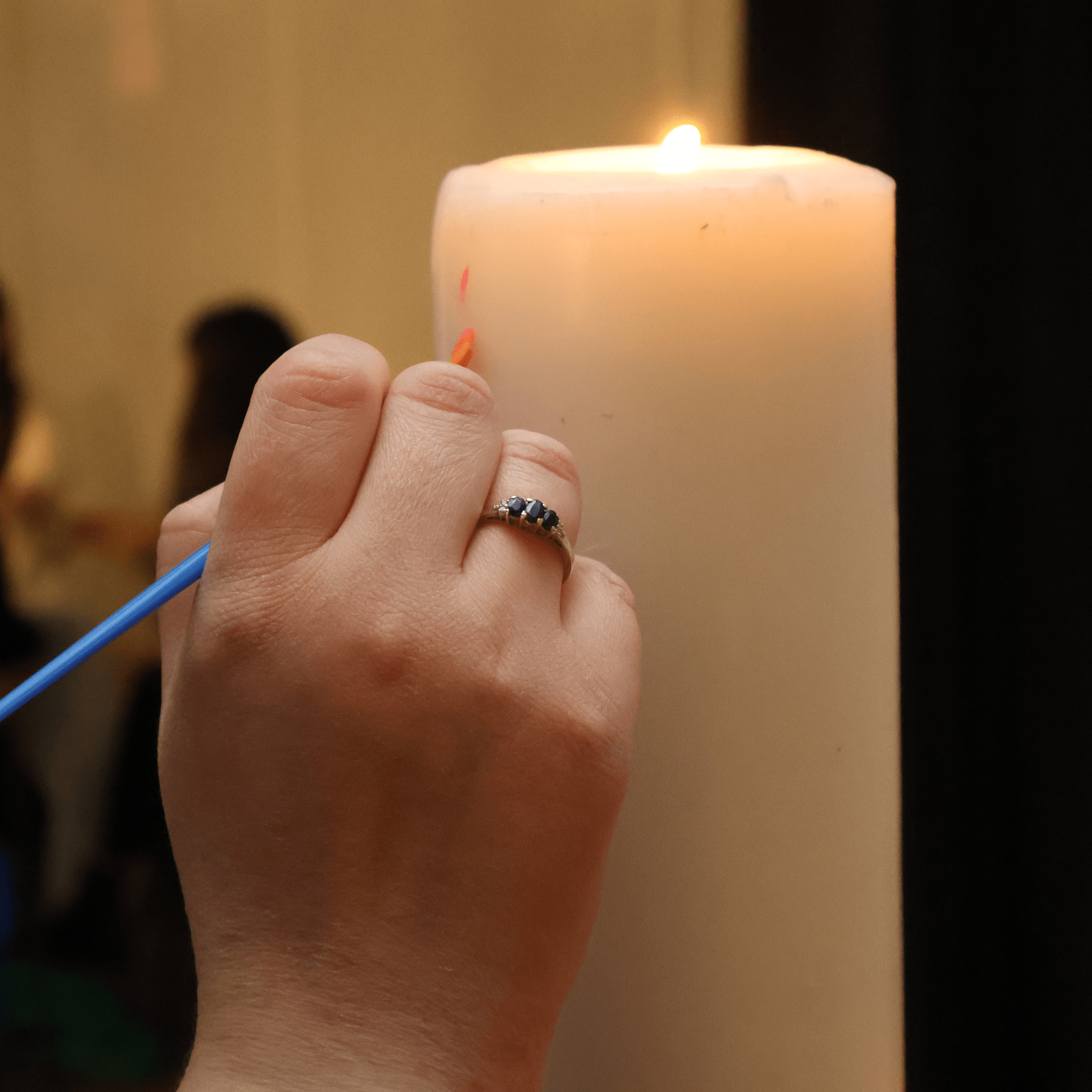 decorating a lit candle