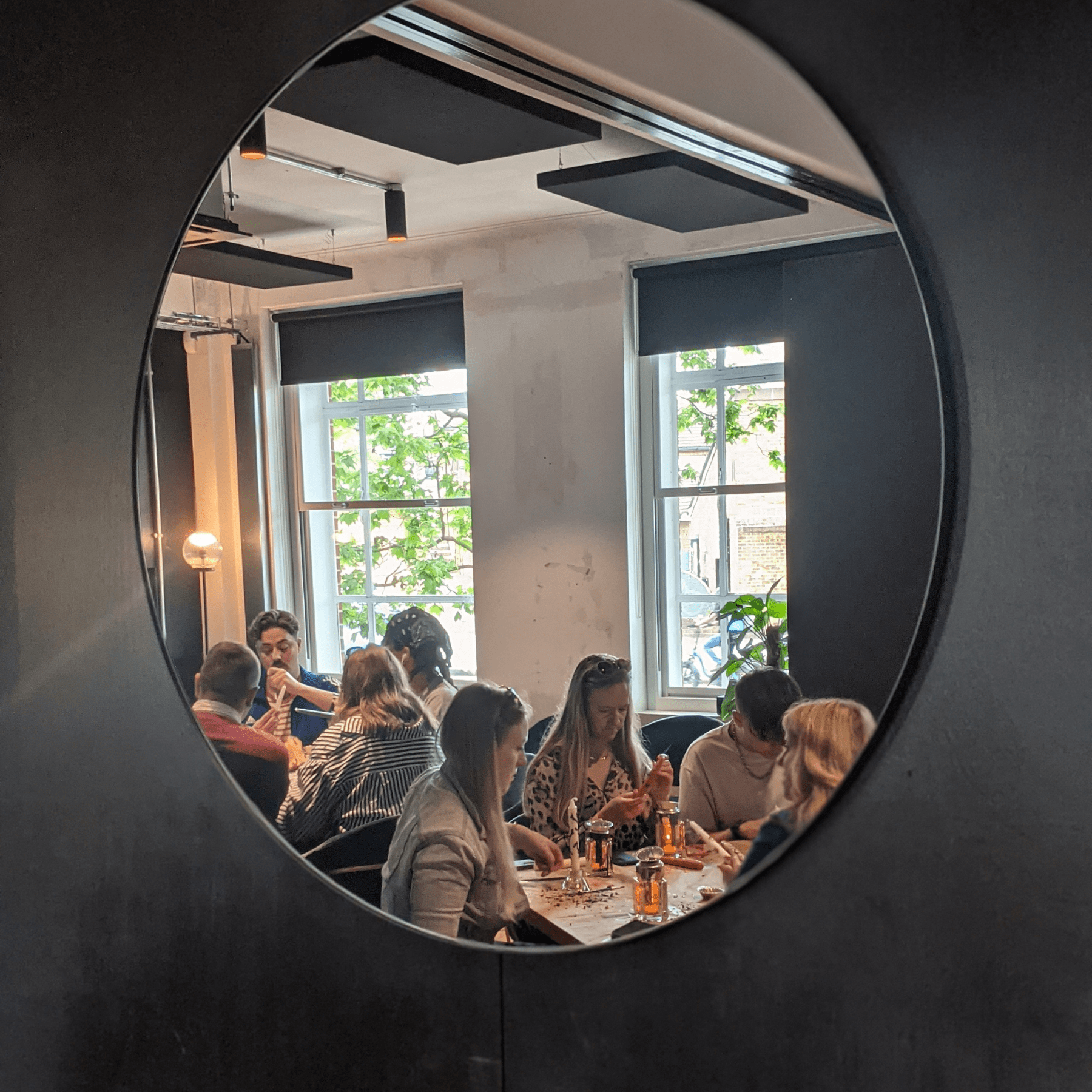 creative workshop reflected in an oval mirror